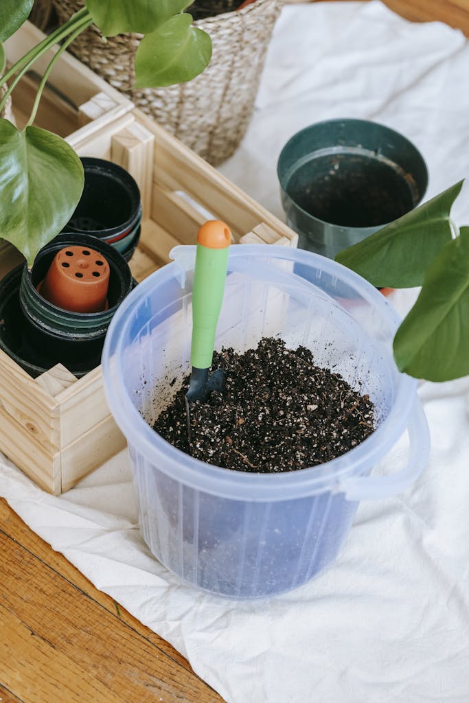 Plastic bucket of soil with spade for an indoor living wall garden